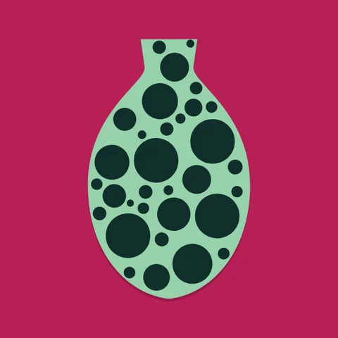 A mint vase covered in dark green dots, on crimson